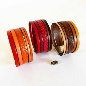 Bracelet manchette cuir 5 liens montés sur fermoir aimanté. Décliné dans des tons rouges, bruns et orange.